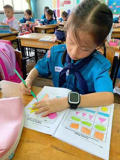 Thai elementary student completing an English assignment