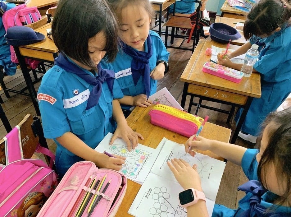 Elementary students in Thailand completing an English assignment