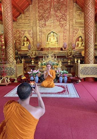 Monks praying at a Buddhist temple in Thailand