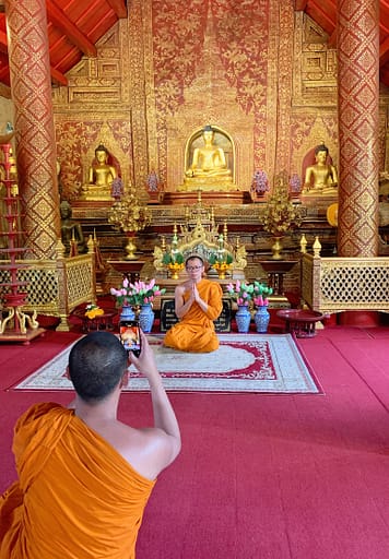 Monks praying at a Buddhist temple in Thailand