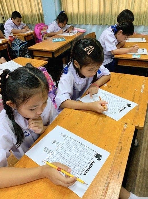 Students in Thailand completing an English assignment